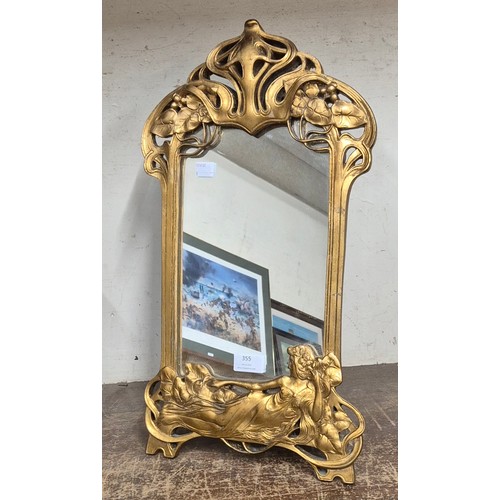 355 - An Art Nouveau style gilt framed strut mirror