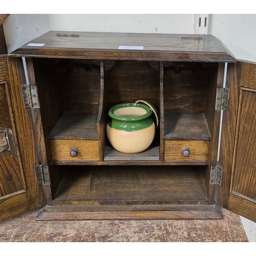 360 - An Art Nouveau carved oak and copper smokers cabinet