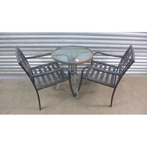 2191 - A pair of metal garden chairs and a circular glass topped garden table - diameter - 2ft