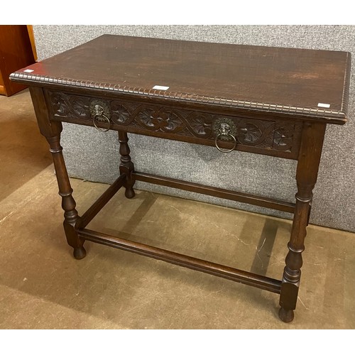 201 - A Charles II style carved oak single drawer side table