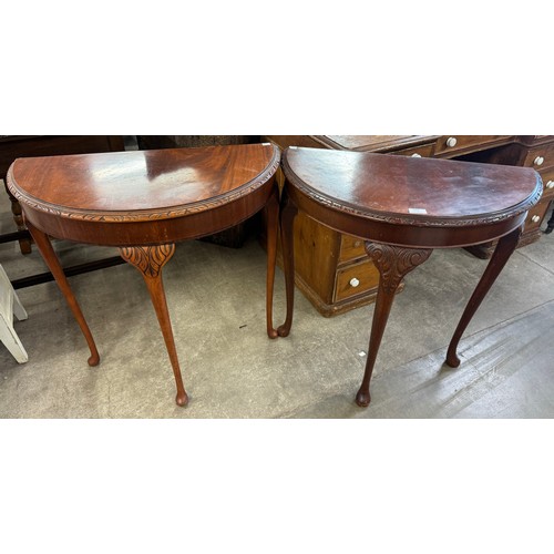 225 - A pair of similar Queen Anne style walnut demi-lune hall tables