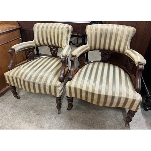 228 - A pair of Victorian carved mahogany and upholstered armchairs