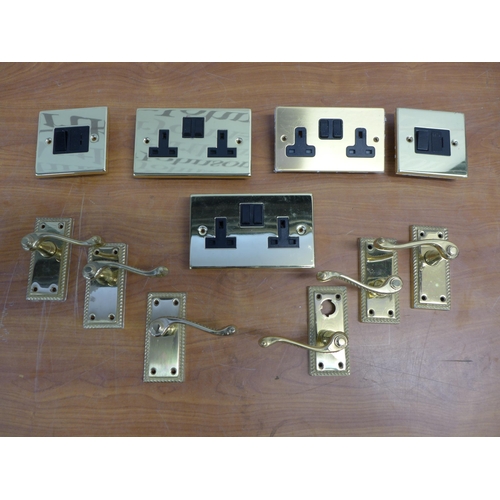 2352 - A box of 22 brass door handles, brass sockets and switches