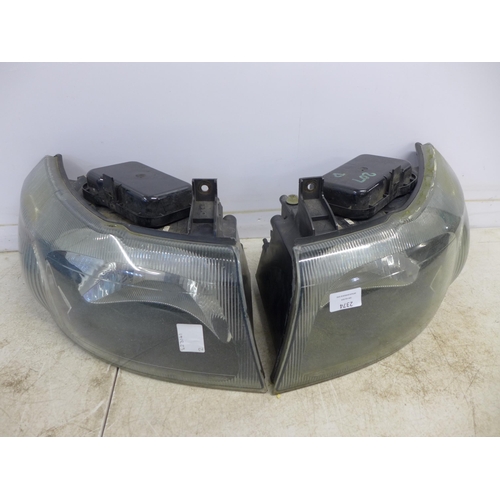 2374 - A pair of headlights for a Ford Transit van