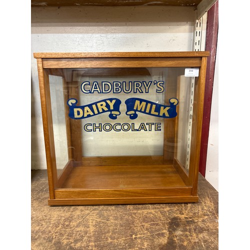 394 - An oak shop counter display cabinet, bearing Cadbury's Dairy Milk inscription