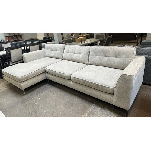 1409 - An oatmeal textured weave upholstered corner sofa/chaise on stiletto legs