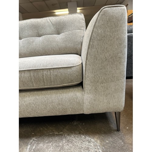 1409 - An oatmeal textured weave upholstered corner sofa/chaise on stiletto legs