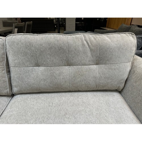 1409 - An oatmeal textured weave upholstered corner sofa/chaise on stiletto legs