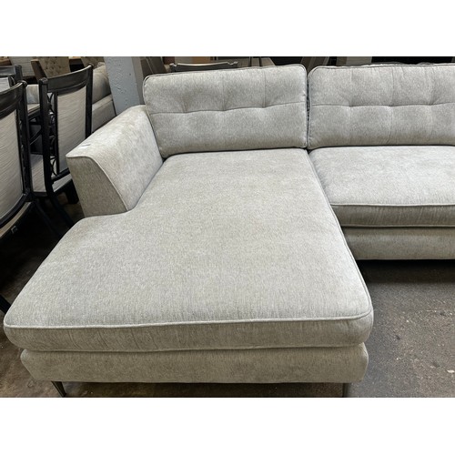 1409 - An oatmeal textured weave upholstered corner sofa/chaise on stiletto legs