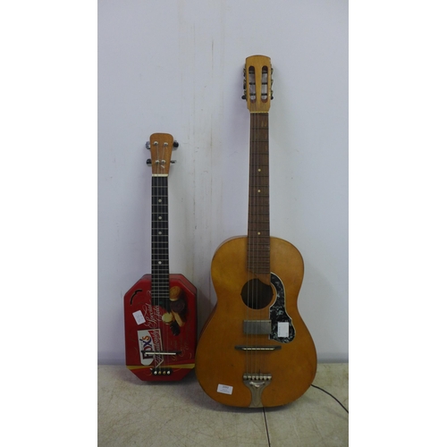 2093 - A 6 string homemade electro-acoustic guitar and a 4 string acoustic guitar made out of a Fox's biscu... 