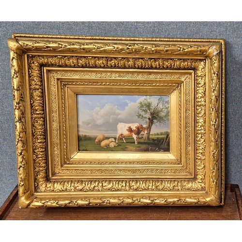 67 - A 19th Century style landscape with a cow and sheep in a field, oil on board, 16 x 26cms, framed