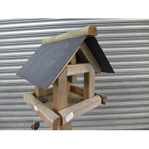 2239 - A wooden bird table with slate roof