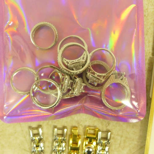 2102 - A box of assorted jewellery including white metal rings stamped S925, 5 metal plated bracelets and 1... 