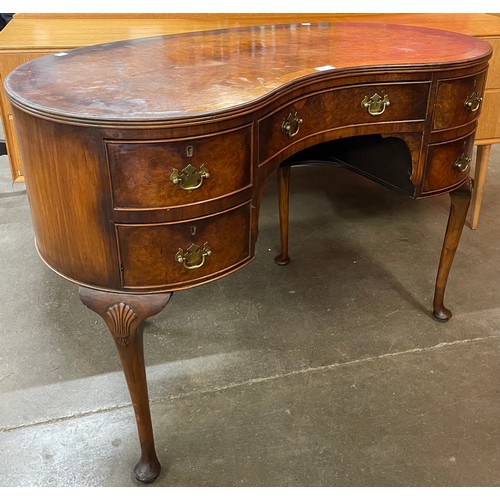 149 - A Queen Anne style walnut kidney shaped desk