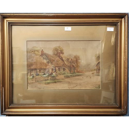 80 - Ernest Potter, thatched cottages in a village, signed lower right, 29 x 44cms, framed