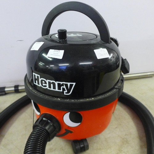 2121 - A Henry Numatic vacuum cleaner with multiple cleaning attachments