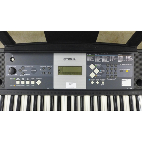 2135 - A Yamaha model YPT-230 61 key electronic keyboard with power supply, music stand and keyboard stand