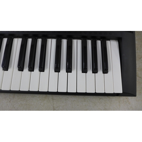 2135 - A Yamaha model YPT-230 61 key electronic keyboard with power supply, music stand and keyboard stand