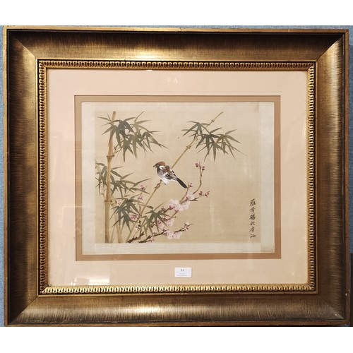 94 - A Chinese watercolour on silk, bird amongst bamboo and blossom, 36 x 47cms, framed