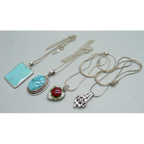 1009 - Four silver pendants and chains