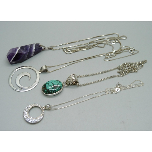 1011 - Four silver pendants and chains including an amethyst quartz and a turquoise set pendant