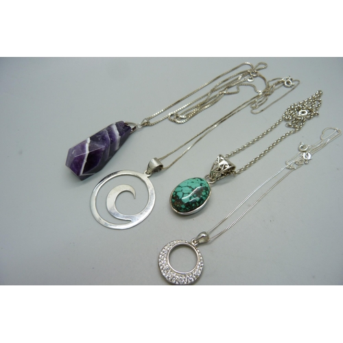 1011 - Four silver pendants and chains including an amethyst quartz and a turquoise set pendant