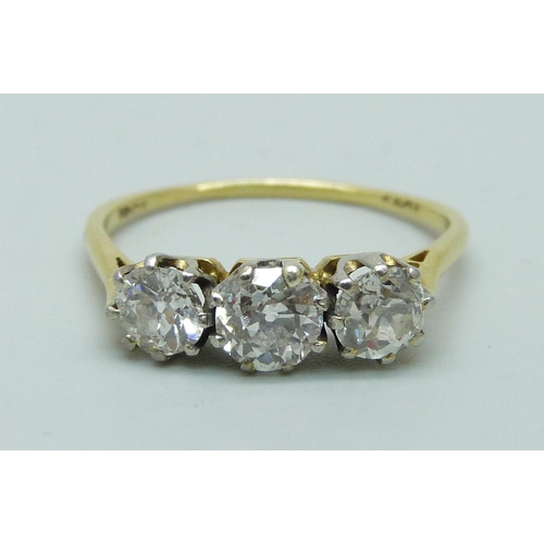 1019 - An 18ct gold three stone diamond ring, approximately 1.5cts diamond weight, 2.8g, T