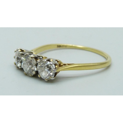 1019 - An 18ct gold three stone diamond ring, approximately 1.5cts diamond weight, 2.8g, T