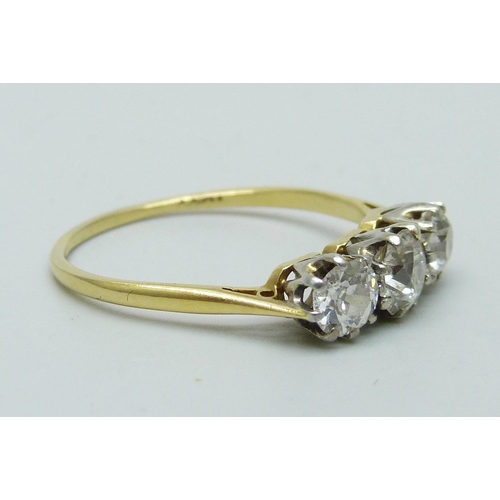 1019 - An 18ct gold three stone diamond ring, approximately 1.5cts diamond weight, 2.8g, T