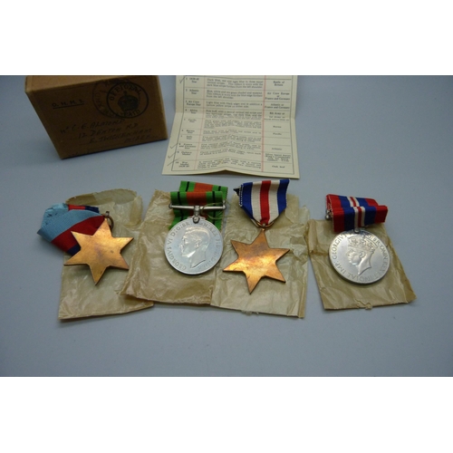 1036 - Four WWII medals all in original postage box certificate addressed to C.E. Almond, Twickenham, Middl... 