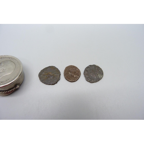 1069 - A small novelty peaked cap set with a one penny coin and three Roman coins