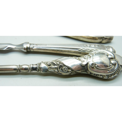 1072 - A silver backed hand mirror, a letter opener and a button hook