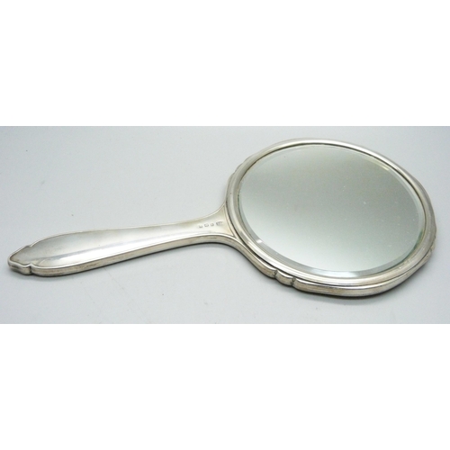 1072 - A silver backed hand mirror, a letter opener and a button hook