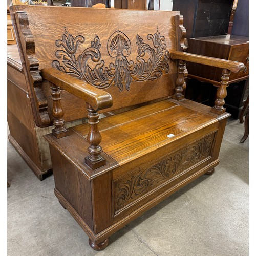 309 - A 17th Century style carved oak monks bench