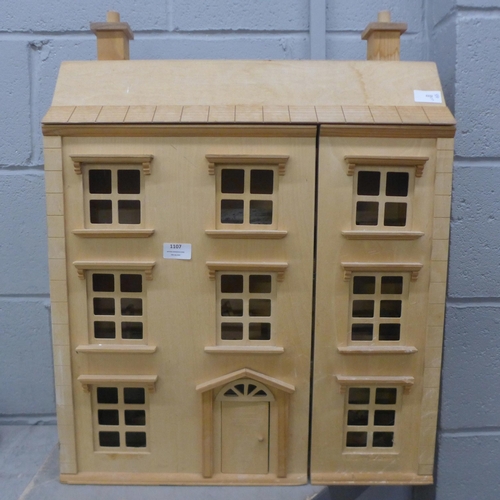 1107 - A three storey wooden dolls house with some furniture and accessories **PLEASE NOTE THIS LOT IS NOT ... 