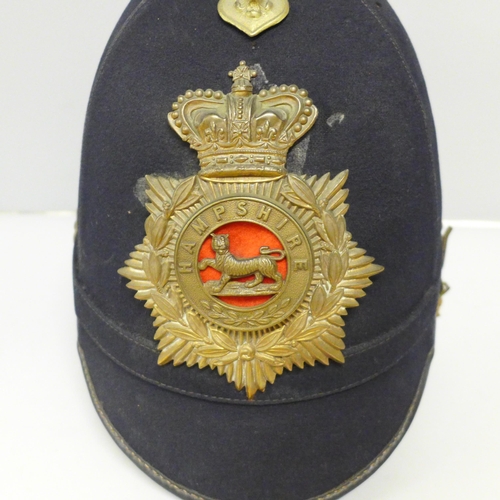 602 - A Hampshire regiment blue cloth helmet, issue mark 1911