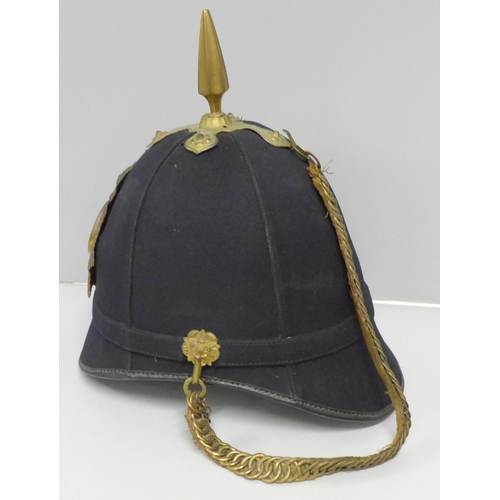 602 - A Hampshire regiment blue cloth helmet, issue mark 1911