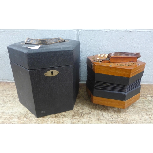 612 - A cased concertina squeezebox