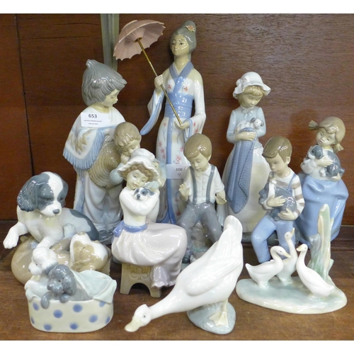 653 - Eleven Nao by Lladro models together with a Casades figure of a lady with a parasol