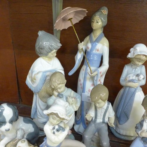 653 - Eleven Nao by Lladro models together with a Casades figure of a lady with a parasol