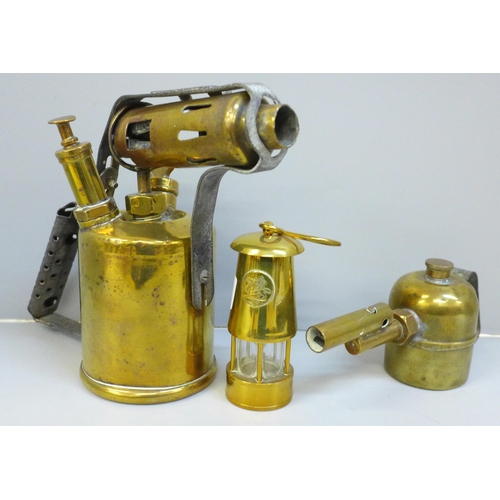 669 - A brass blow torch, small brass burner and a Welsh miniature miner's lamp