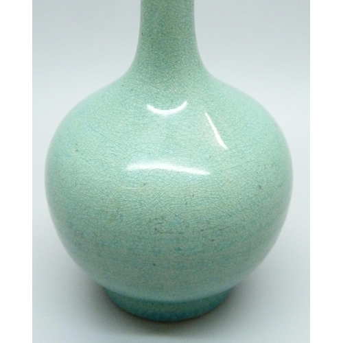 685 - An early 20th Century Japanese celadon glazed bottle shaped porcelain vase, chip to base, 12.5cms h