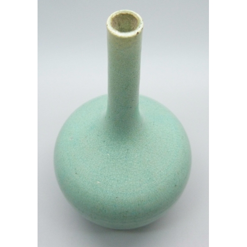 685 - An early 20th Century Japanese celadon glazed bottle shaped porcelain vase, chip to base, 12.5cms h