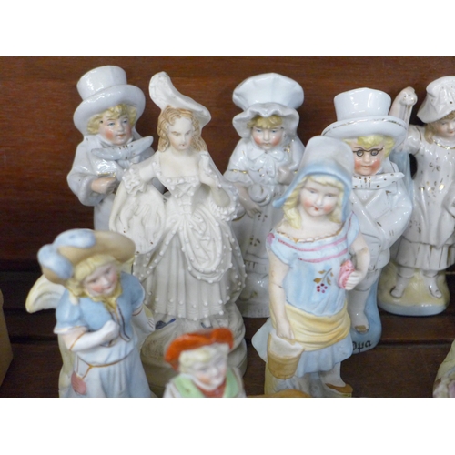 689 - A large collection of English and Continental porcelain and bisque figures, including three children... 