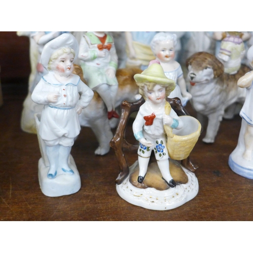 689 - A large collection of English and Continental porcelain and bisque figures, including three children... 