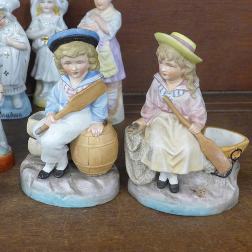 689 - A large collection of English and Continental porcelain and bisque figures, including three children... 