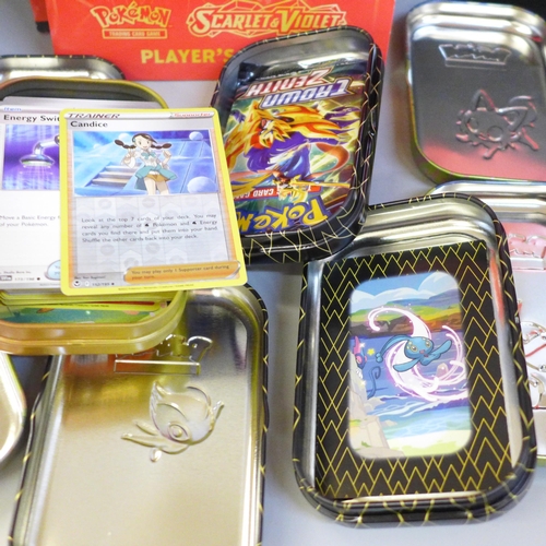 741 - A Pokemon Elite Trainer box, eight mini tins and a large tin, some containing cards and two Pokeball... 