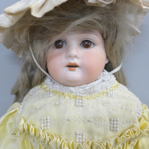 762 - A German Armand Marseille bisque head doll, brown sleep eyes, 370 stamp, 51cm