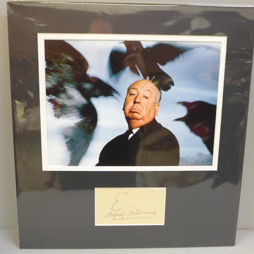 767 - An Alfred Hitchcock autographed display, (no COA)