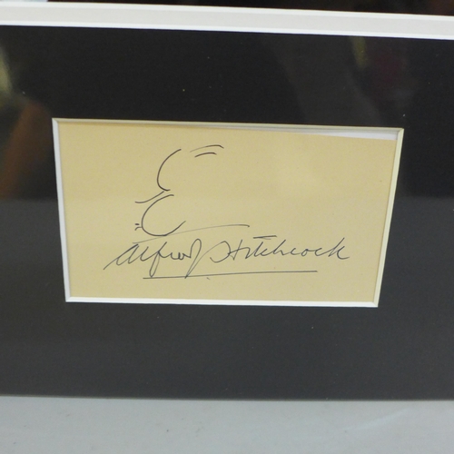 767 - An Alfred Hitchcock autographed display, (no COA)